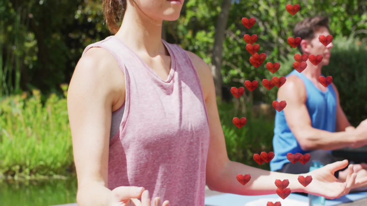 Yogis meditating, hearts rising around them as one shifting into lotus for wellness