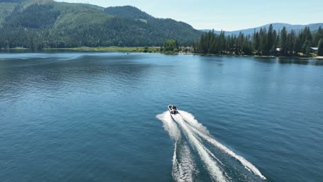 drone shot of a motorboat traveling through spirit lake in idaho