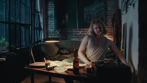 man drinking coffee and beer in an old apartment