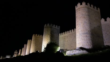 avila at night, featuring the glowing medieval walls and ancient old town, recognized as a unesco world heritage site in spain.