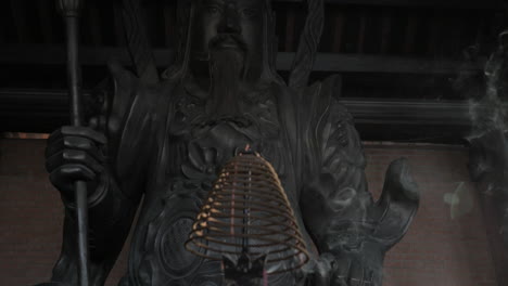 incense and statue of warrior in bai dinh temple vietnam