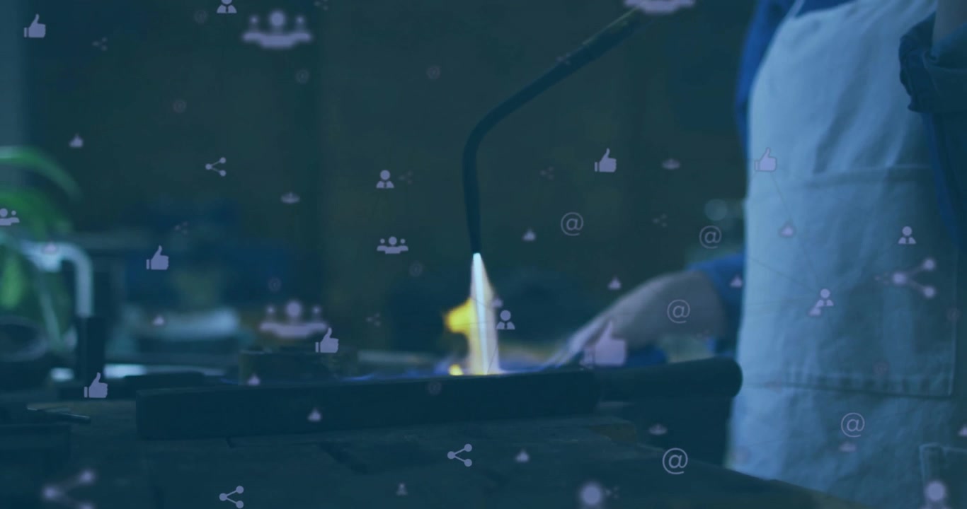 Metalworker opening valve and igniting torch flame for softening metal, with floating social icons