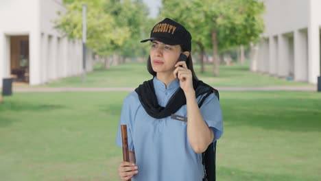 angry indian female security guard fighting with someone on call