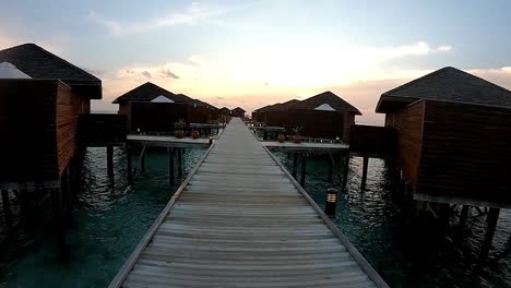 overwater villas at sunset in the maldives