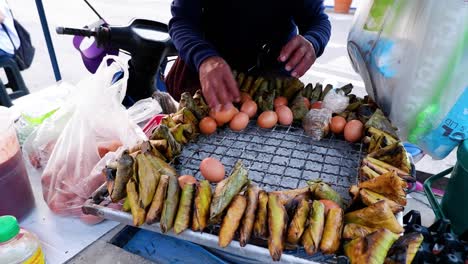 vendor grilling sticky rice and arranging boiled eggs