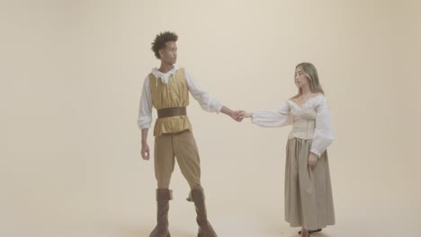 man and woman wearing ancient roman costumes in indoor studio for content production stock