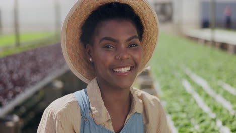 happy woman farmer in greenhouse