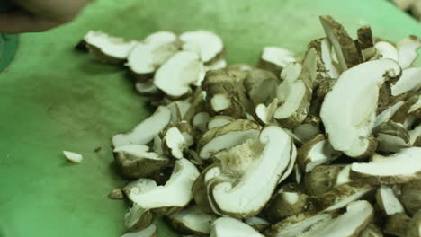 expert chef chopping lots of mushrooms to small cuts effortlessly