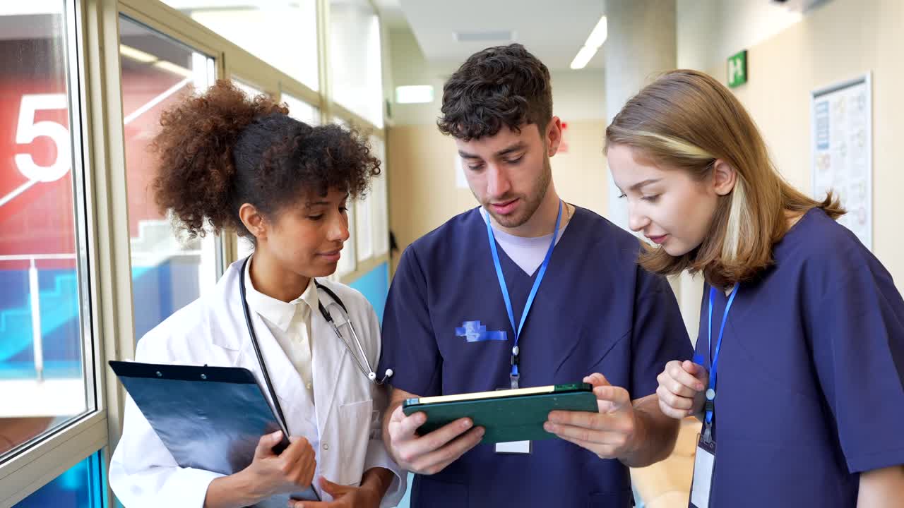 Medical Staff Collaborating in Hospital Hallway