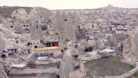 goreme town with mosque and residences in rock formations, cappadocia region, turkey