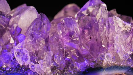 elegant, fluid pan of sparkling purple amethyst crystal against a rich, dark background