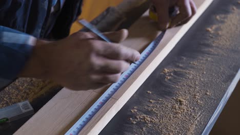 close-up wooden measure. the carpenter is measuring with the meter.