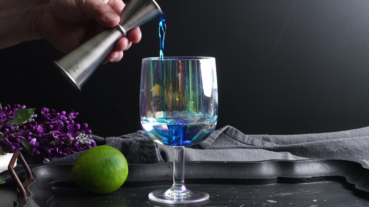Vibrant cocktail with a striking blue hue from blue curacao, mixed with the zesty of lime juice. Vodka adds a smooth, bold finish, garnished with a lime wheel and fresh mint for a refreshing twist.