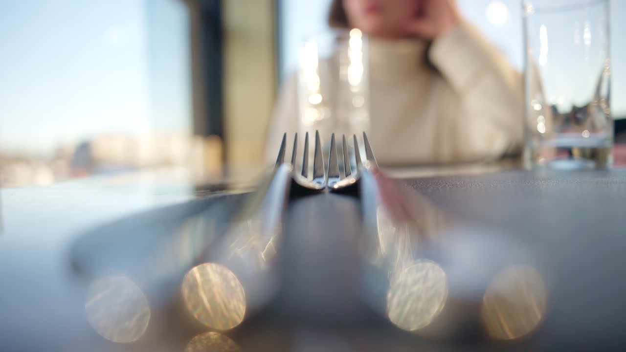 Close up silver forks on a plate at a restaurant