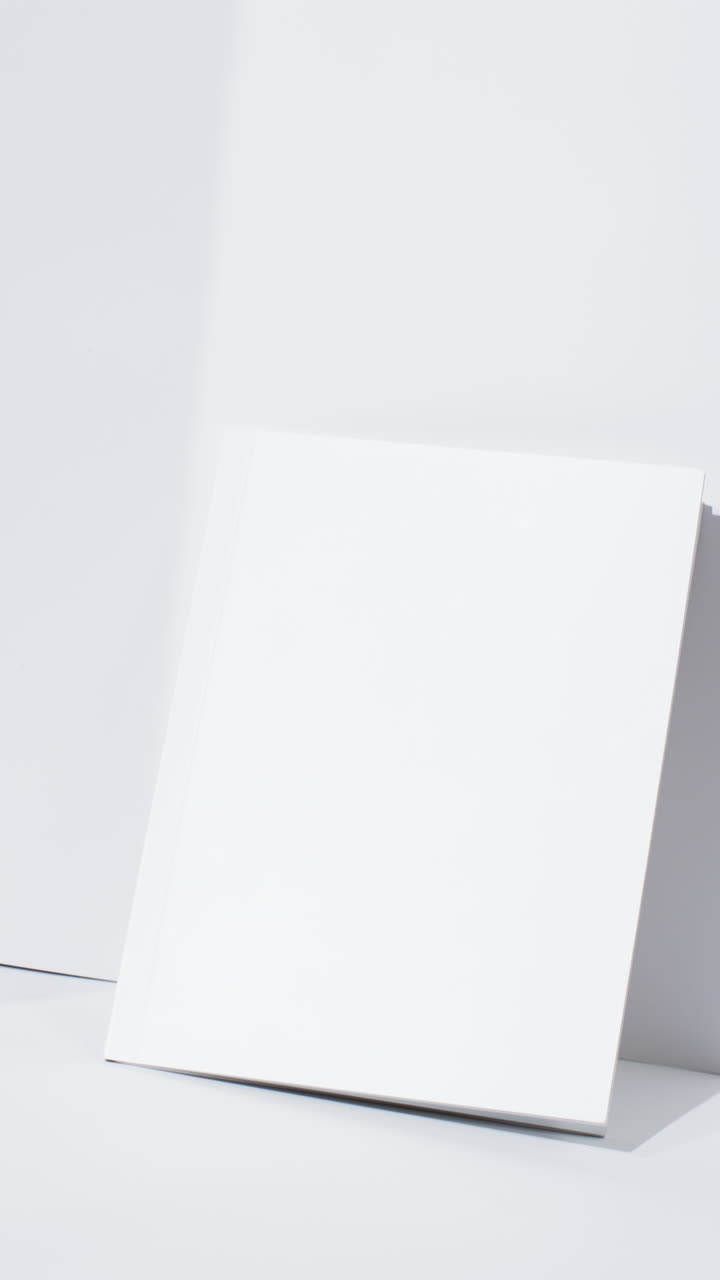 Vertical video of book with blank pages and copy space on white background