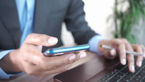 businessman using smartphone and laptop