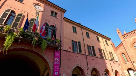 a picturesque square with flags and architecture