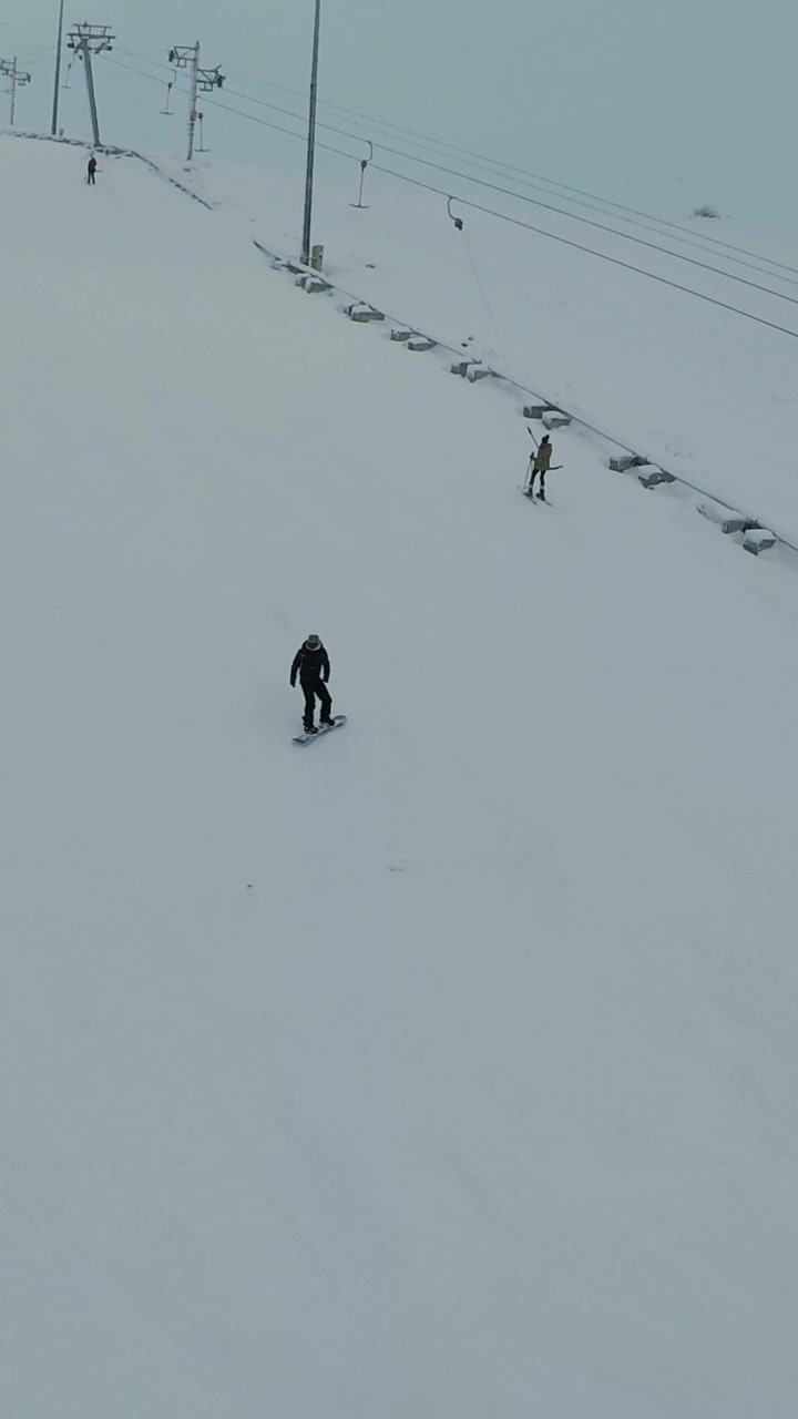 Snowboarding and Skiing on a Snowy Mountain