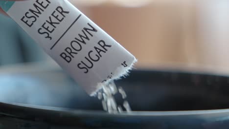 pouring brown sugar from packet