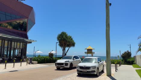 cars parked near lifeguard tower, sunny day