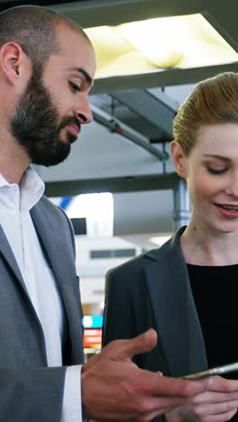 business people discussing over smartphone