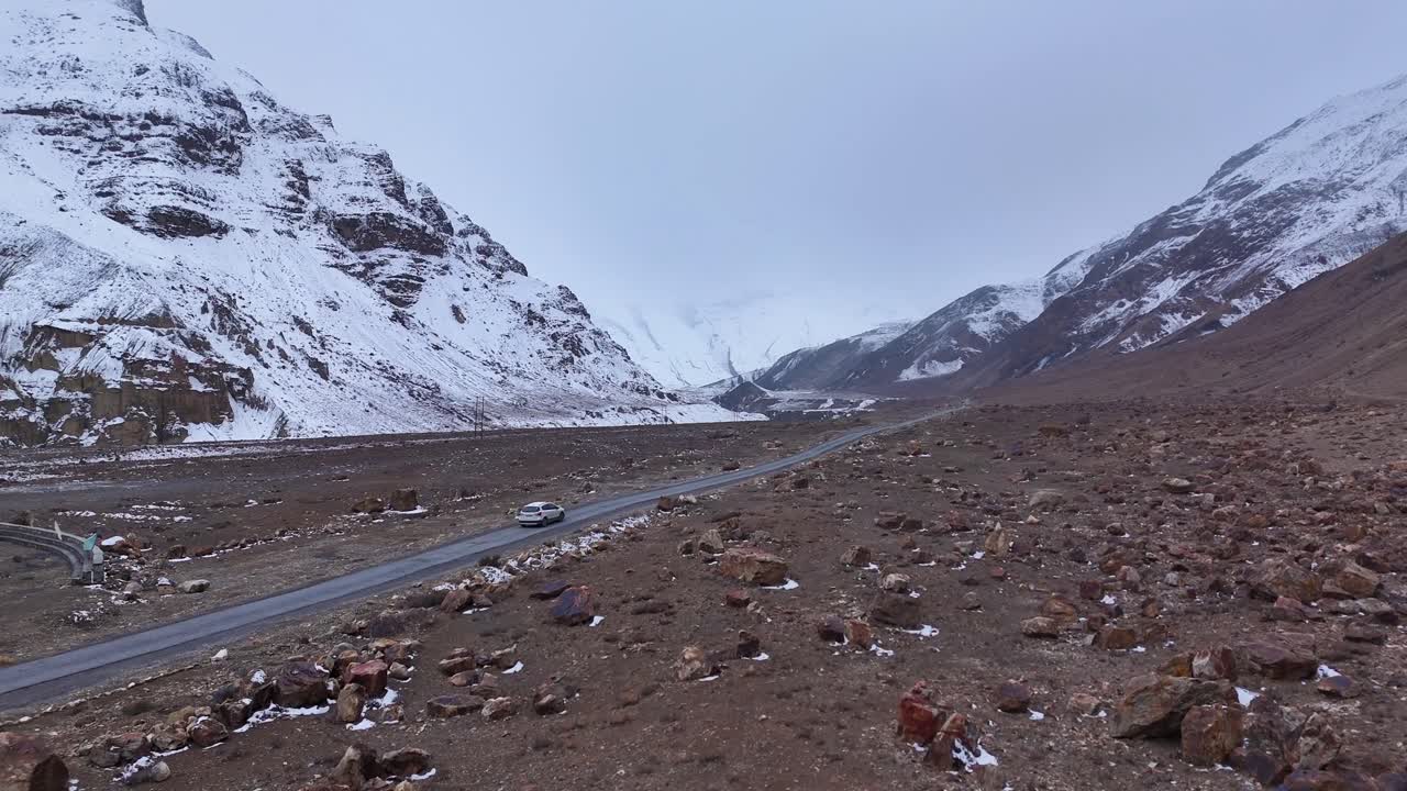Snowy Mountain Road with a Car