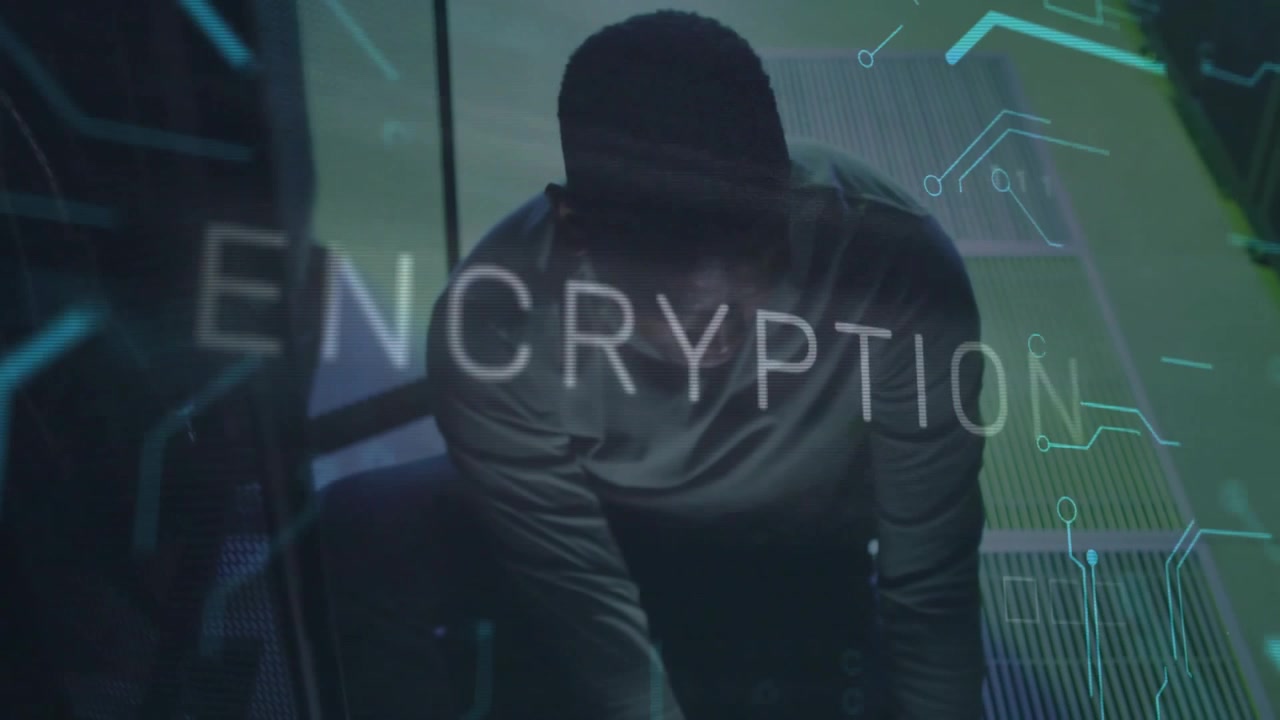 Male technician typing and monitoring data center encryption, glitchy overlay animating circuits