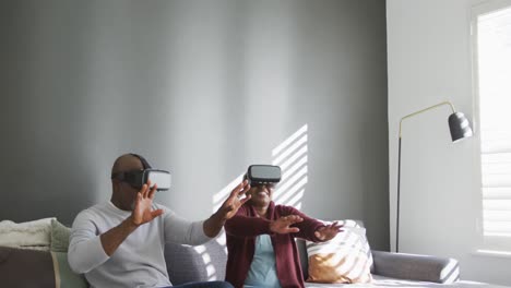 Happy-african-american-senior-couple-wearing-vr-headset-and-having-fun