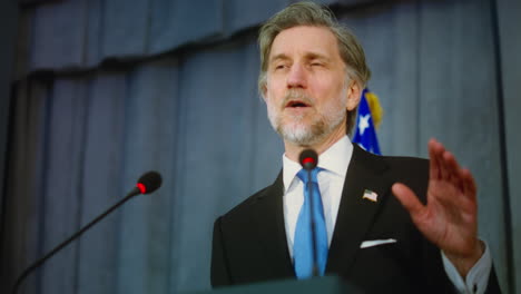 man giving a speech at a press conference