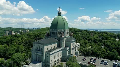 4k cinematic urban landscape footage of a drone flying around the observatory saint joseph in montreal, quebec on a sunny day, behind mount royal capturing a beautiful panoramic view