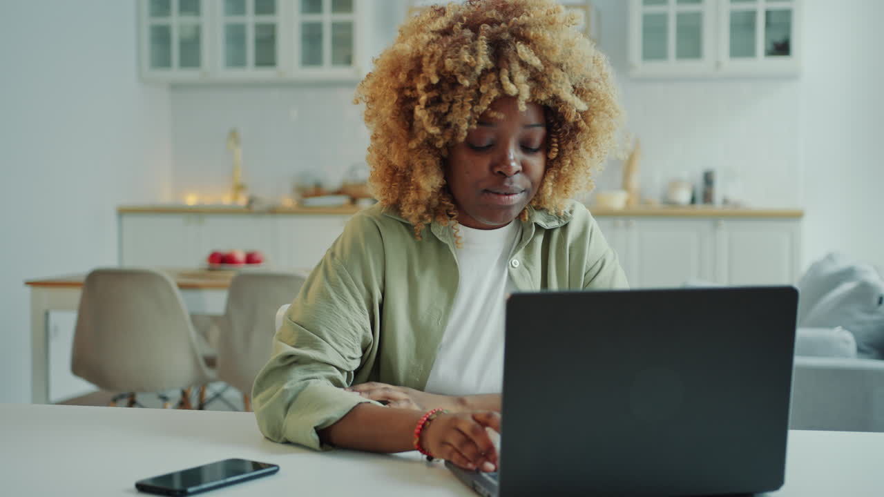 Young Black Woman Speaking via Video Call on Laptop at Home