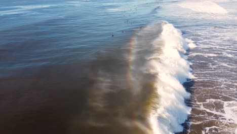 Drone-aerial-landscape-scenic-shot-of-wave-break-on-sandbar-shoreline-with-surfers-in-line-up-Central-Coast-tourism-NSW-Australia-4K