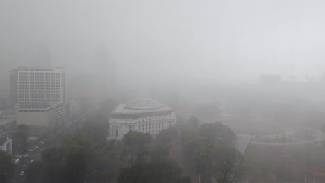 aerial view of national museum in rizal park during torrential rain downpour and poor visibility in capital city of manila philippines