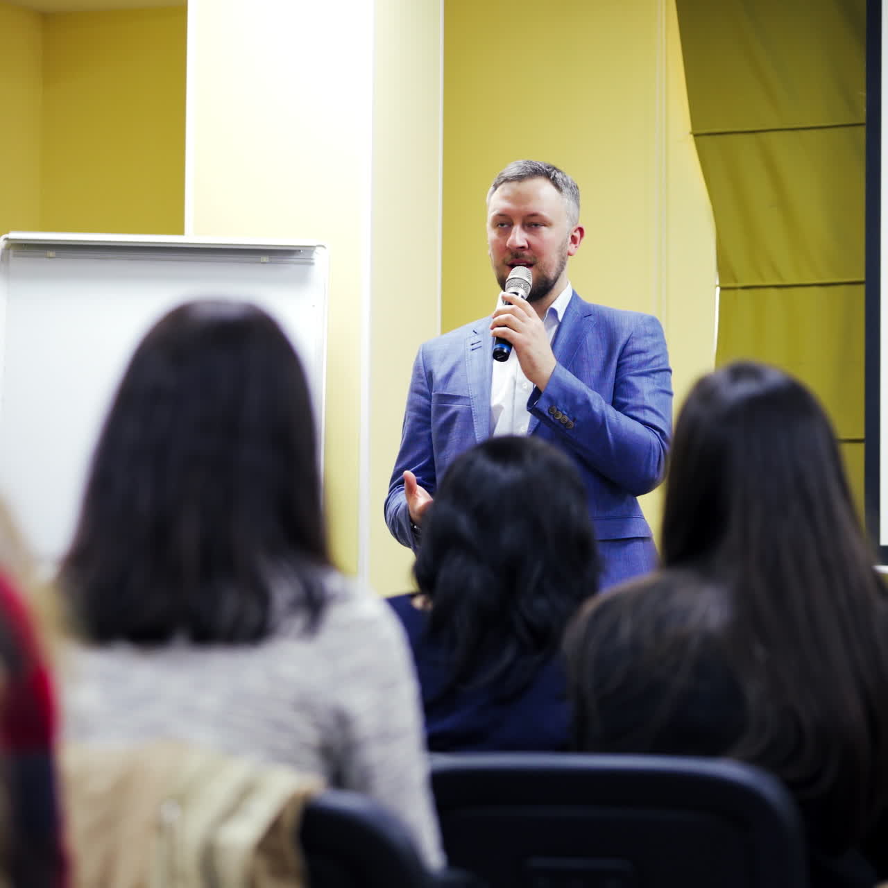 young businessman at business conference room with public giving presentations. Audience at the conference hall. Entrepreneurship club
