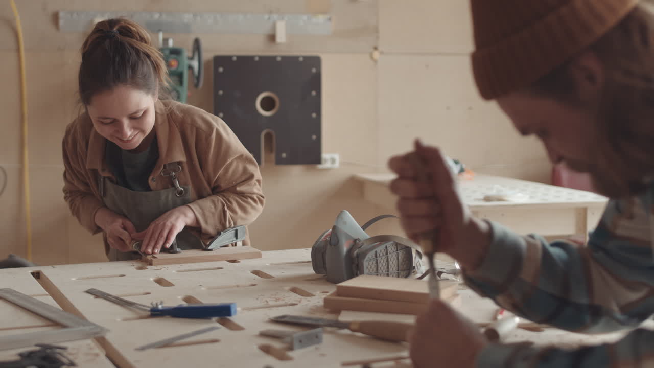 Two Joiners Carving Pieces of Wood