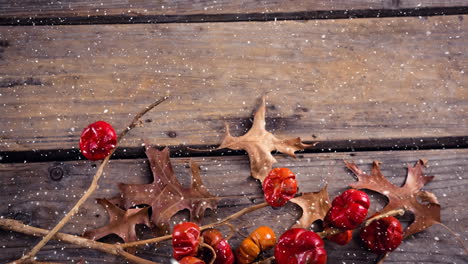 falling snow with christmas leaves on wood