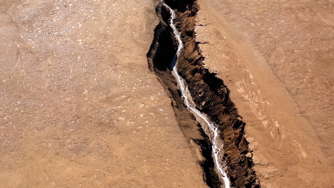 Deep Fissure in Arid Desert Landscape