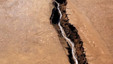 deep fissure in arid desert landscape
