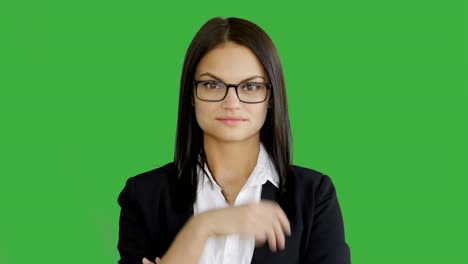 young attractive brunette women standing isolated against green screen background. portrait of beautiful professional female person in suit