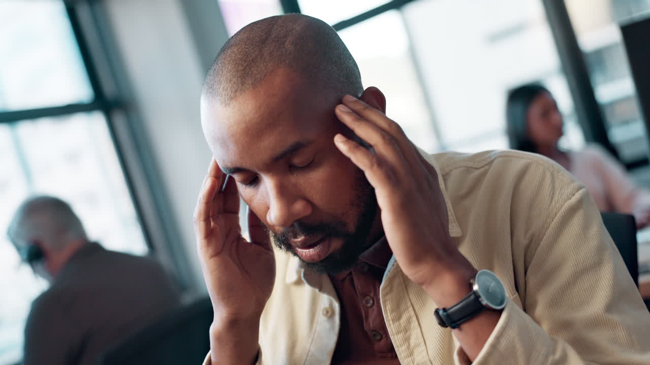 Man with a headache in the office
