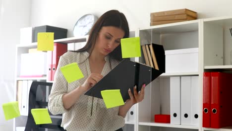 businesswoman marking sticky notes on glass wall