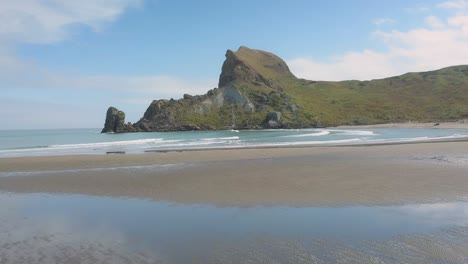 aerial approach of castle rock over the beach at castlepoint, new zealand