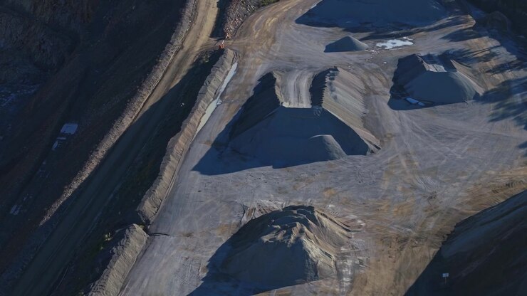 Majestic drone video captures Montrose Quarry in Melbourne, featuring dramatic piles of gravel and expansive excavation sites under crisp daylight, highlighting industrial textures and patterns