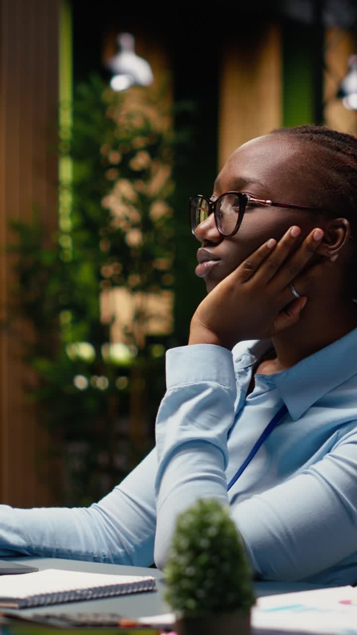 Vertical Video Thoughtful businesswoman pondering solution to a challenging project