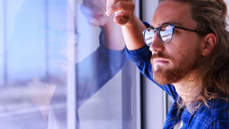 male executive looking through window in office 4k