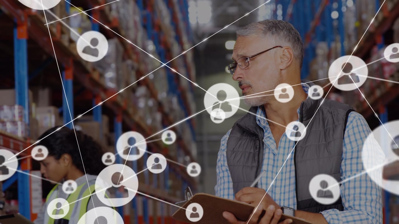 Animation of networks of connection with people icons over caucasian man working in warehouse
