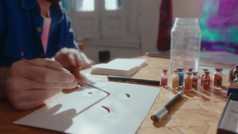 artist mixing dry pigments with water before painting