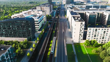 high aerial view over orestad metro line through green urban area, copenhagen