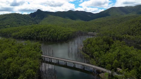 reversing aerial view over pine creek bridge, springbrook national park on the gold coast hinterland, queensland, australia