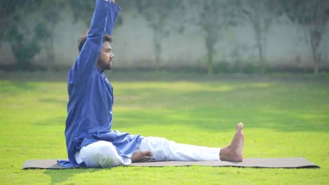 indian man doing knee to head yoga pose in side angle